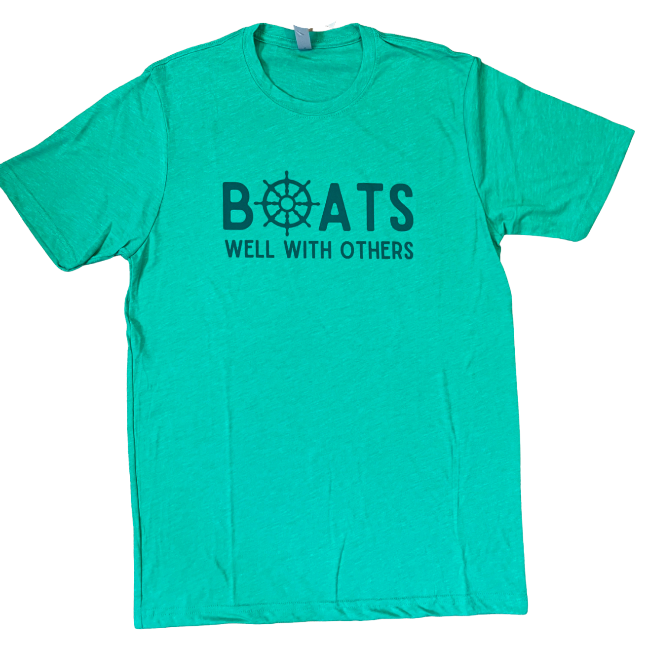 Lay flat of the Boats Well With Others unisex t-shirt in kelly green with blue graphic, showcasing relaxed coastal style