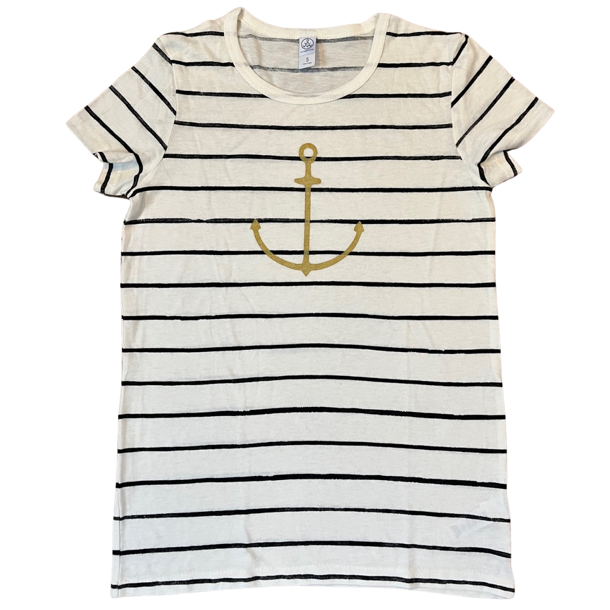 Flat lay of white and black striped t-shirt with a small gold anchor graphic on the chest, displayed on a clean white background