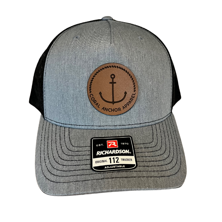 Front view of Coral Anchor Apparel gray and black Richardson 112 trucker hat with leather anchor patch