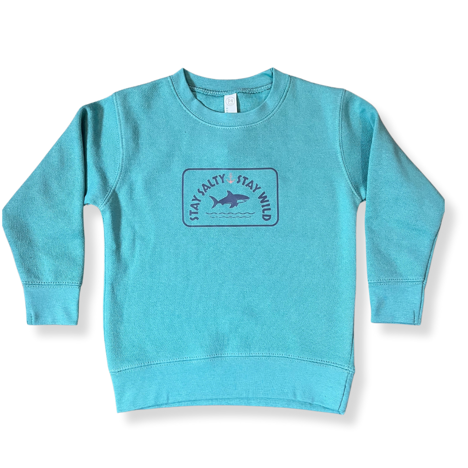 Layflat view of Coral Anchor's toddler crewneck sweatshirt in saltwater blue with shark graphic and "Stay Salty, Stay Wild" text