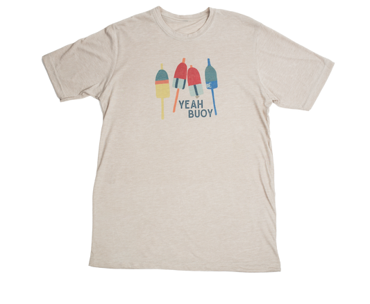 Tan unisex t-shirt with 'Yeah Buoy' nautical graphic, laid flat to show relaxed fit and soft poly-cotton blend by Coral Anchor Apparel.