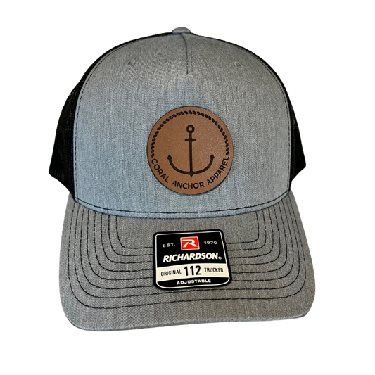 Front view of Coral Anchor Apparel gray and black Richardson 112 trucker hat with leather anchor patch